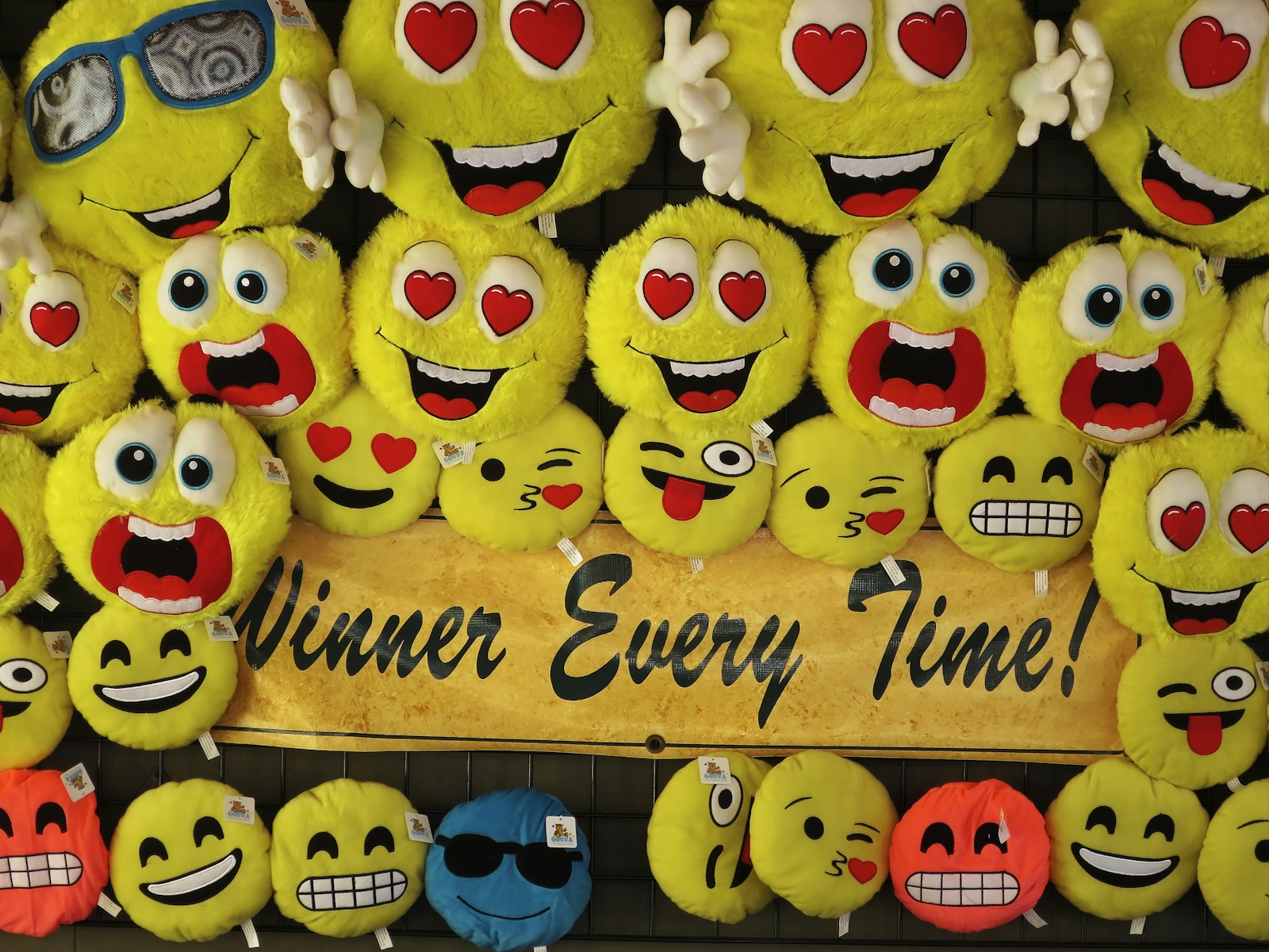 a group of yellow smiley faces with winner every time slogan